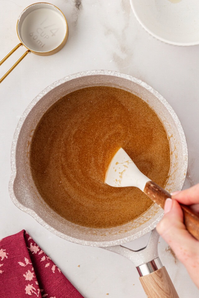 overhead view of milk and salt mixed into melted butter and brown sugar in a saucepan