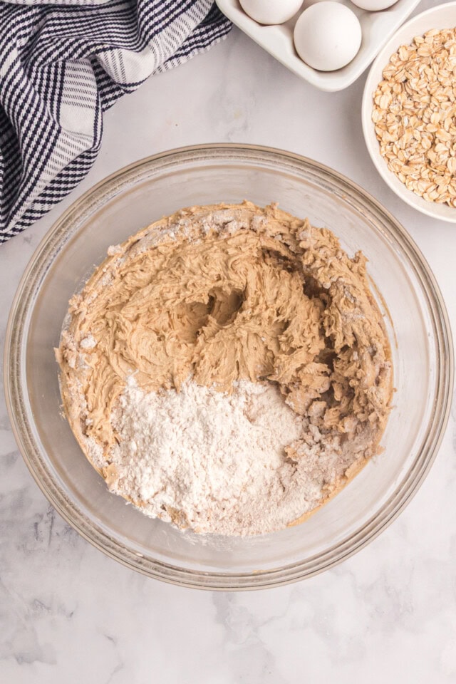 overhead view of dry ingredients added to cookie dough
