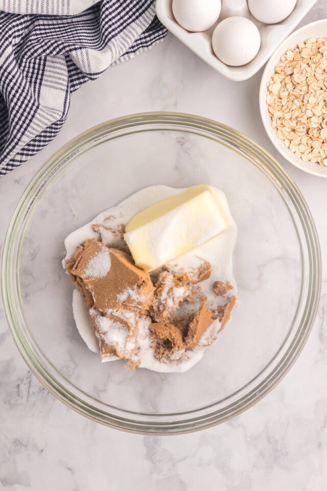 overhead view of butter, sugar, and brown sugar in a glass mixing bowl