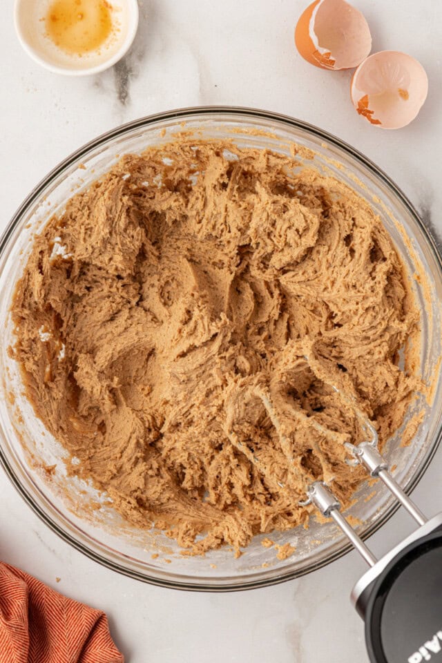 overhead view of sugar and spice cookie dough in a glass mixing bowl