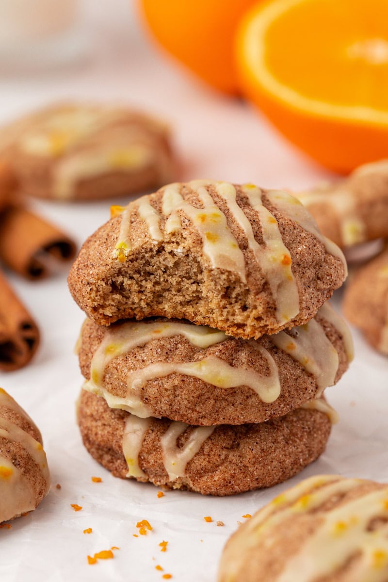 stack of three sugar and spice cookies with a bite missing from the top cookie