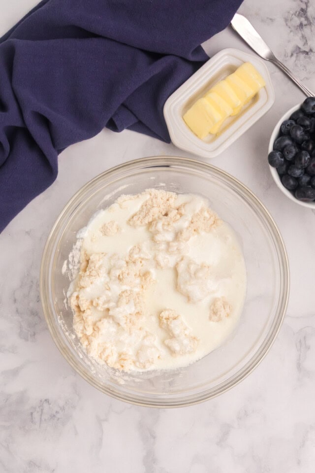 overhead view of cream and buttermilk added to biscuit mixture