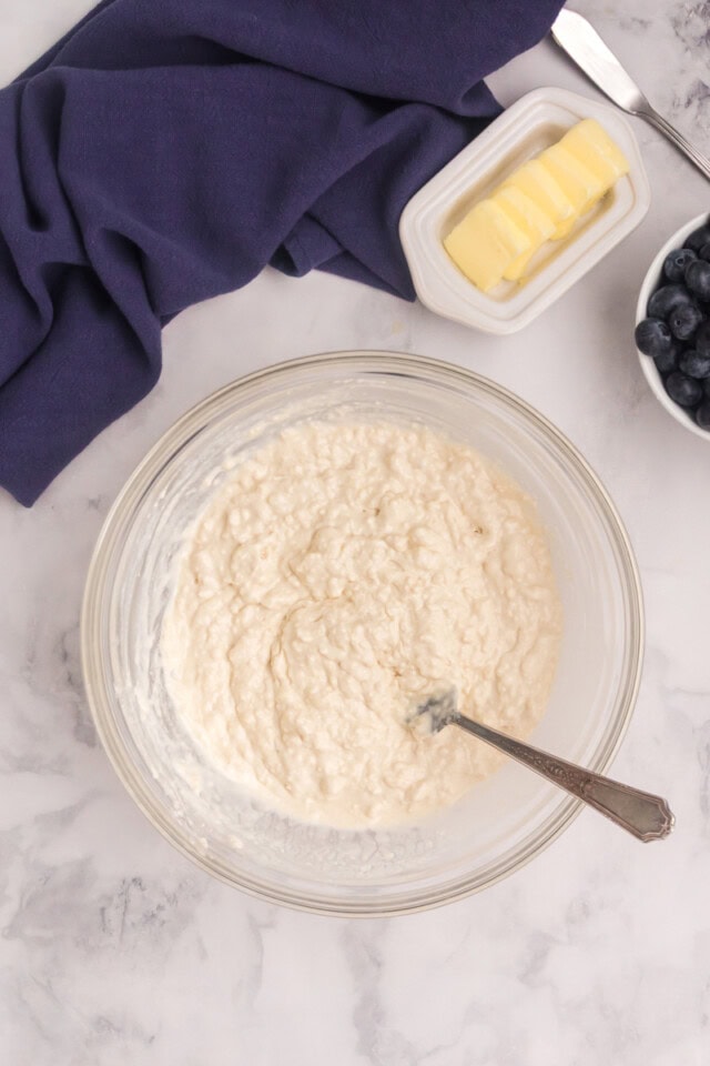 overhead view of touch of grace biscuit dough in a glass mixing bowl