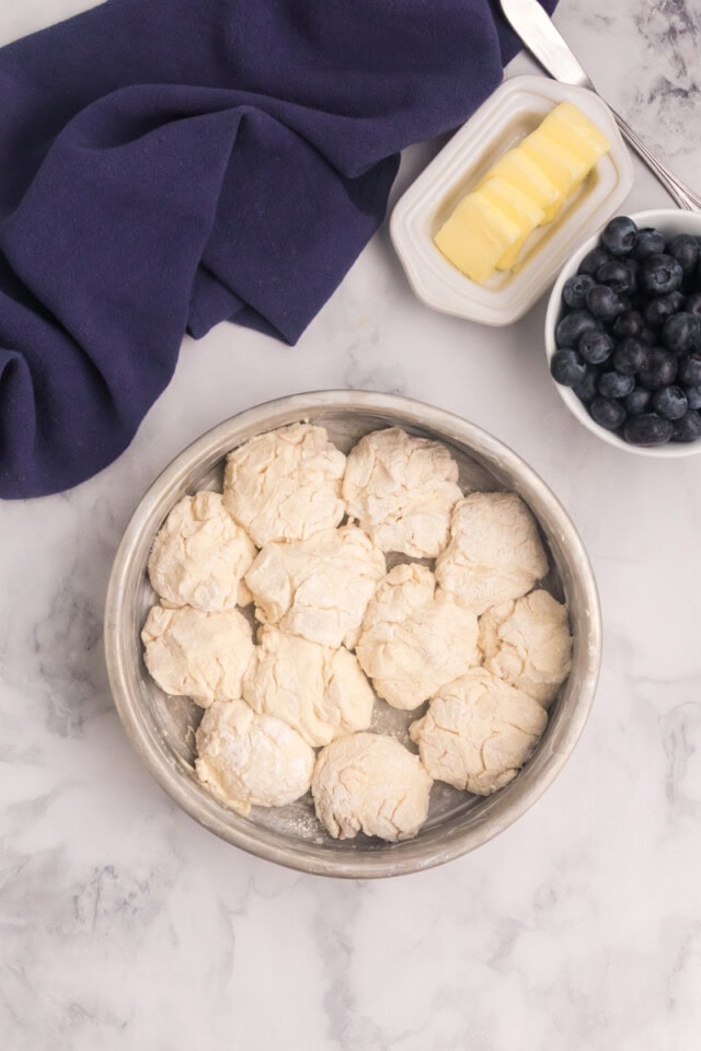 touch of grace biscuit dough in a round pan ready to go into the oven