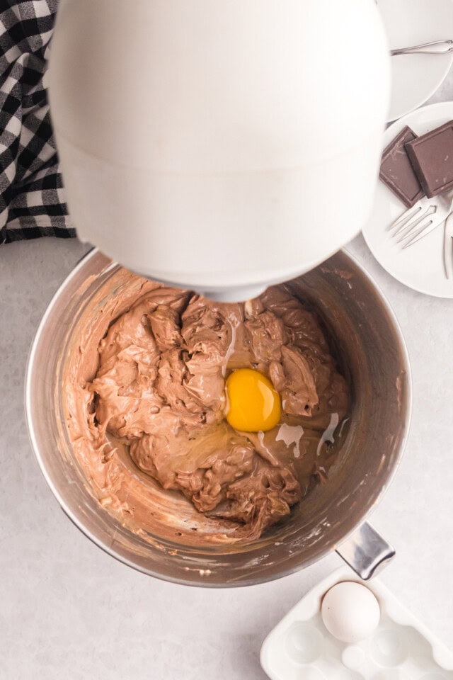 overhead view of egg added to cheesecake mixture