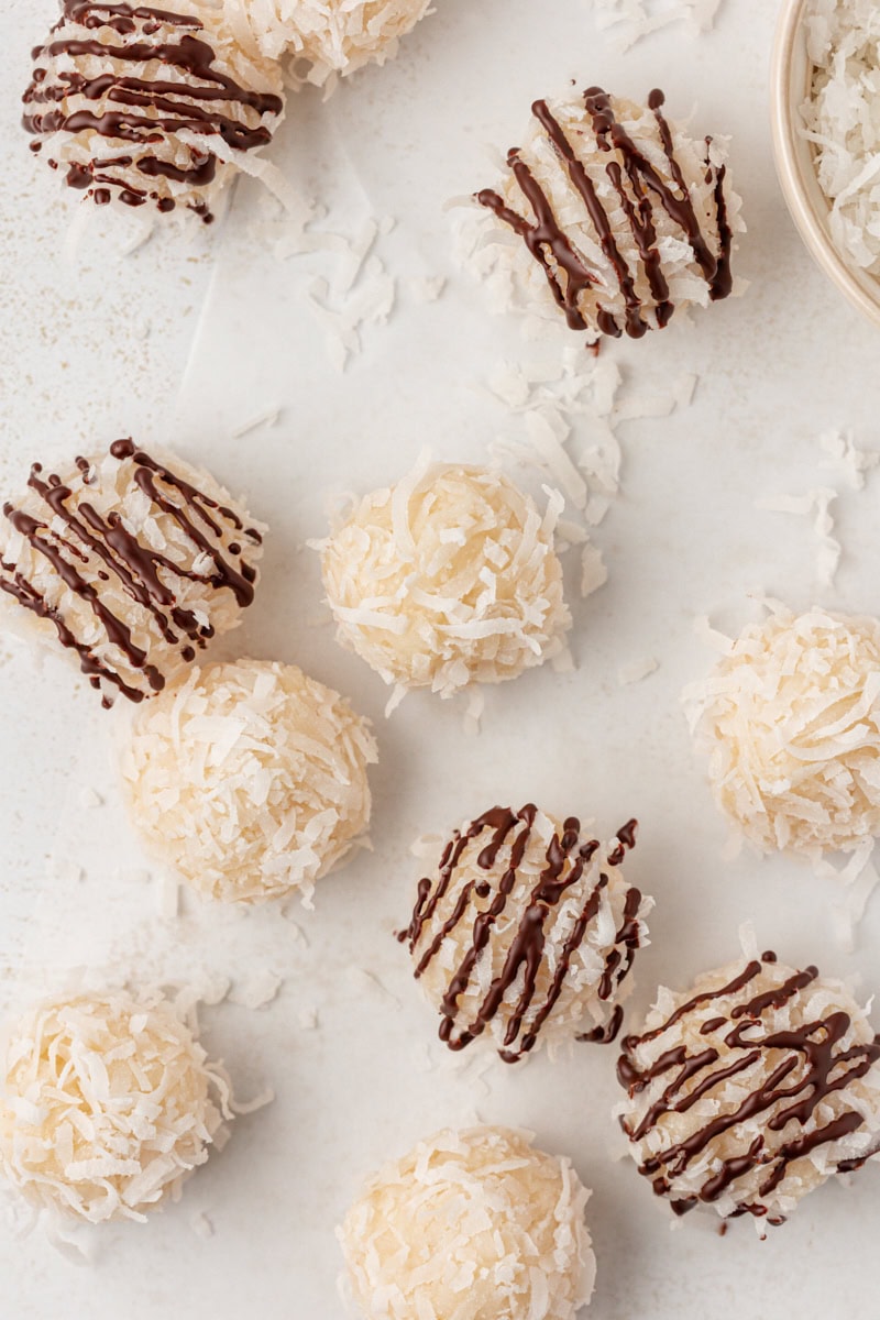 overhead view of coconut snowballs, with some drizzled with chocolate
