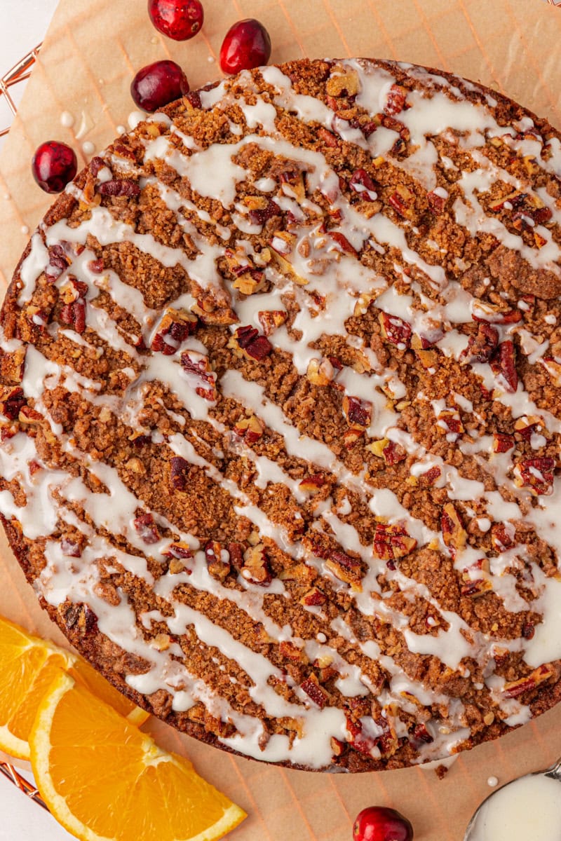 overhead view of cranberry coffee cake topped with a simple orange glaze