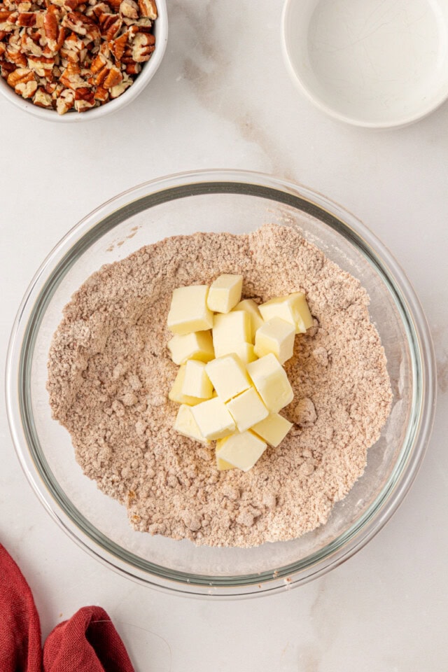 overhead view of cold, cubed butter added to streusel mixture