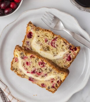 two slices of cranberry cream cheese bread on a white plate