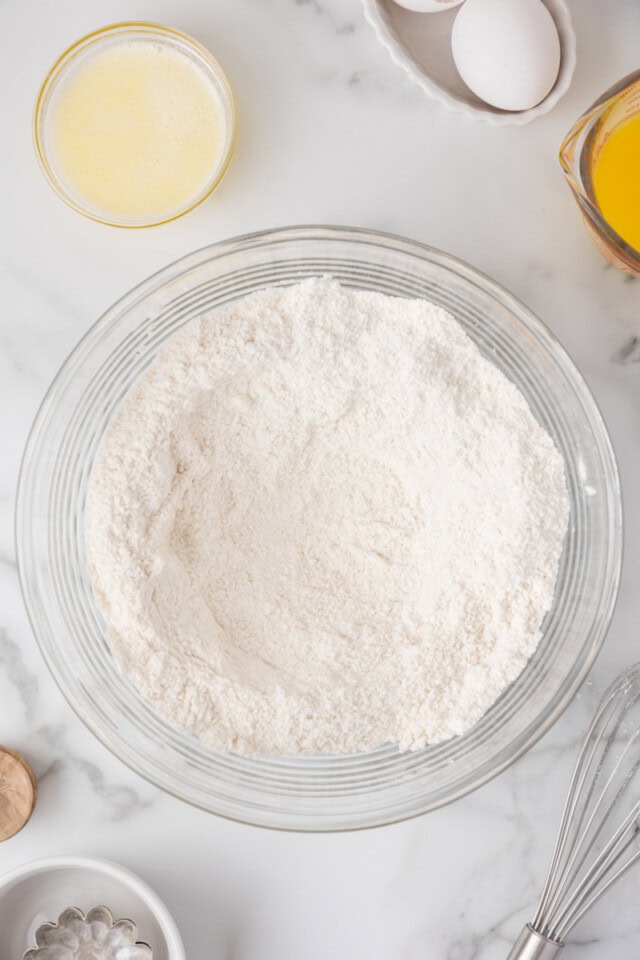 overhead view of combined dry ingredients for quick bread in a glass mixing bowl