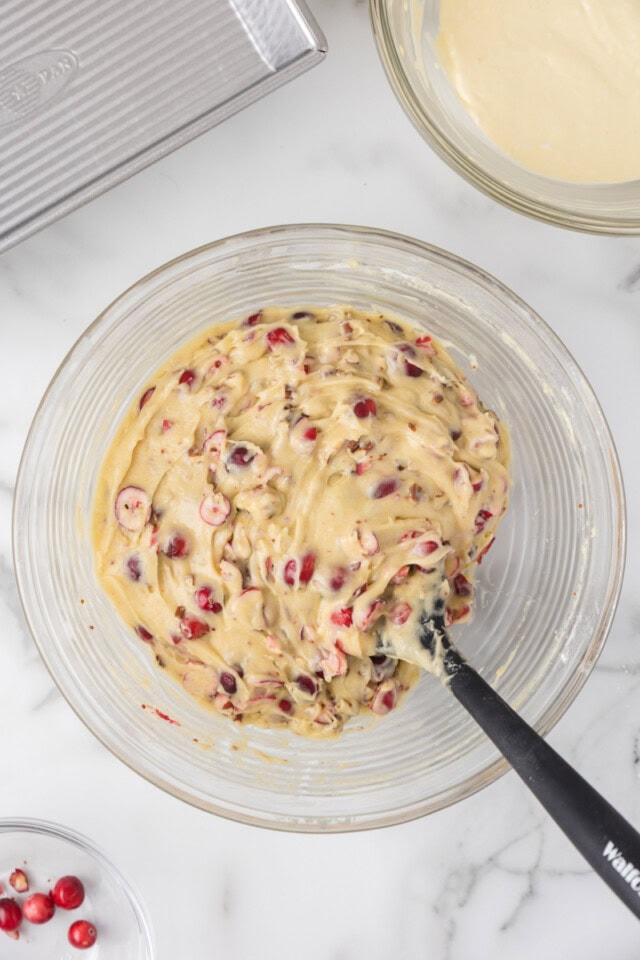 overhead view of cranberry cream cheese bread batter in a glass mixing bowl