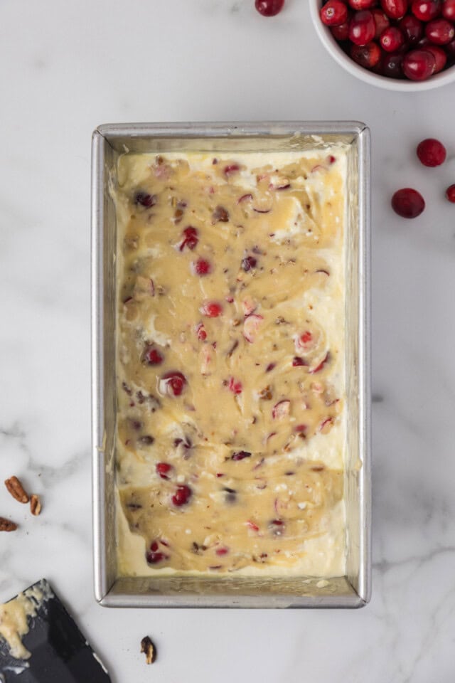 overhead view of cranberry cream cheese bread in a loaf pan ready to go into the oven