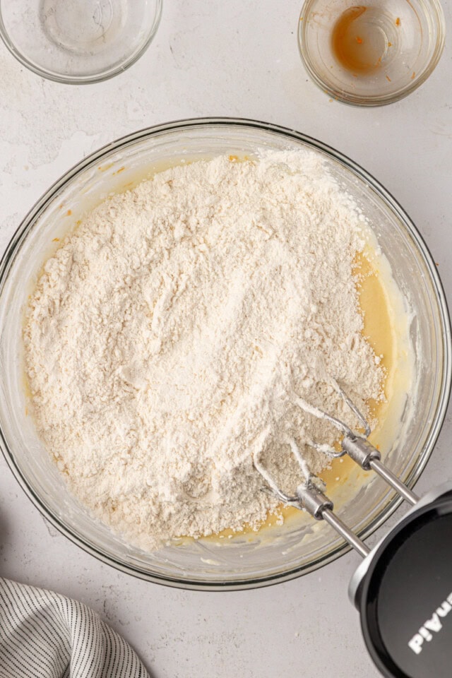 overhead view of dry ingredients added to wet ingredients for orange cookies