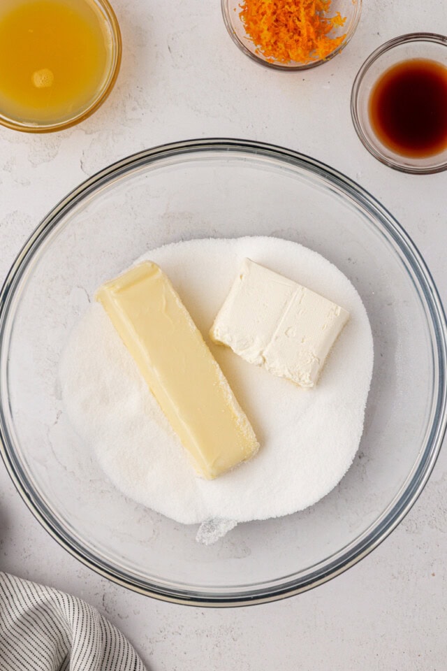 overhead view of butter, cream cheese, and sugar in a mixing bowl