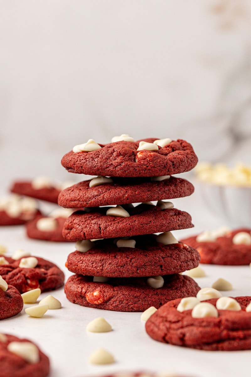 stack of five red velvet cookies with more cookies in the background