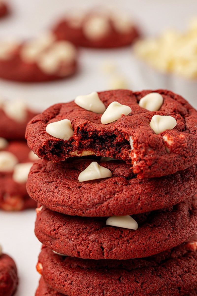 close-up of a stack of red velvet cookies with a bite missing from the top cookie
