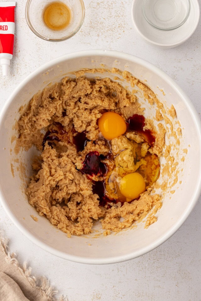 overhead view of eggs and vanilla added to creamed butter and sugars