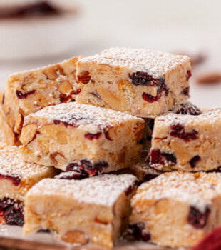 a piled stack of snowflake crisp on a wooden serving board