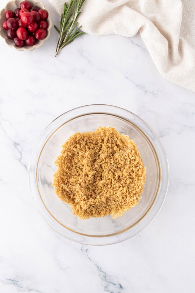 overhead view of graham cracker crust mixture in a small glass bowl