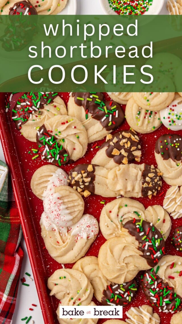 overhead view of whipped shortbread cookies in various shapes and with different toppings on a red tray; text overlay "whipped shortbread cookies bake or break"