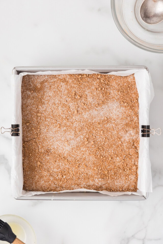 overhead view of cinnamon sugar snack cake in a square baking pan ready to go into the oven
