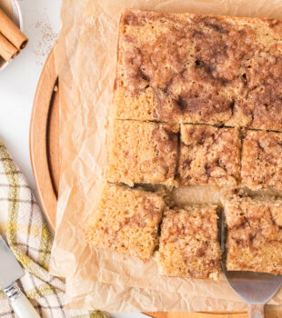 overhead view of sliced cinnamon sugar snack cake on a wooden serving board