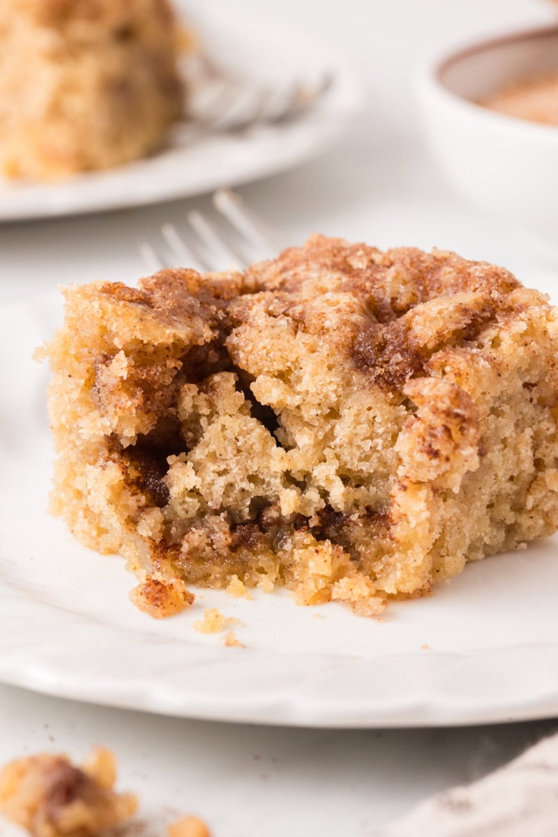 closeup of a slice of cinnamon sugar snack cake with a bite missing