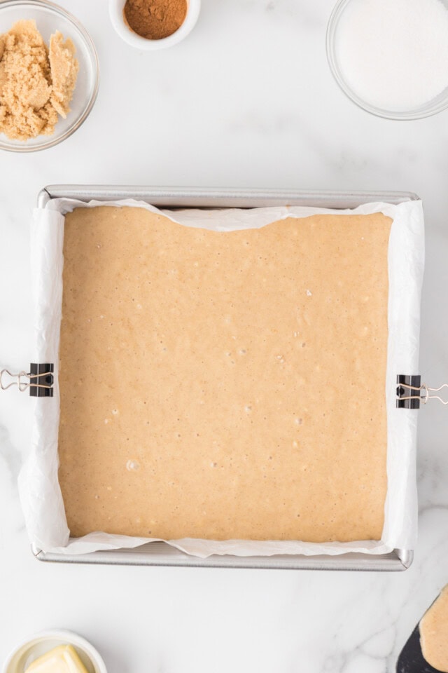 overhead view of cinnamon sugar snack cake batter in a square baking pan