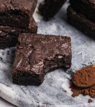 a dark cocoa brownie with a bite missing