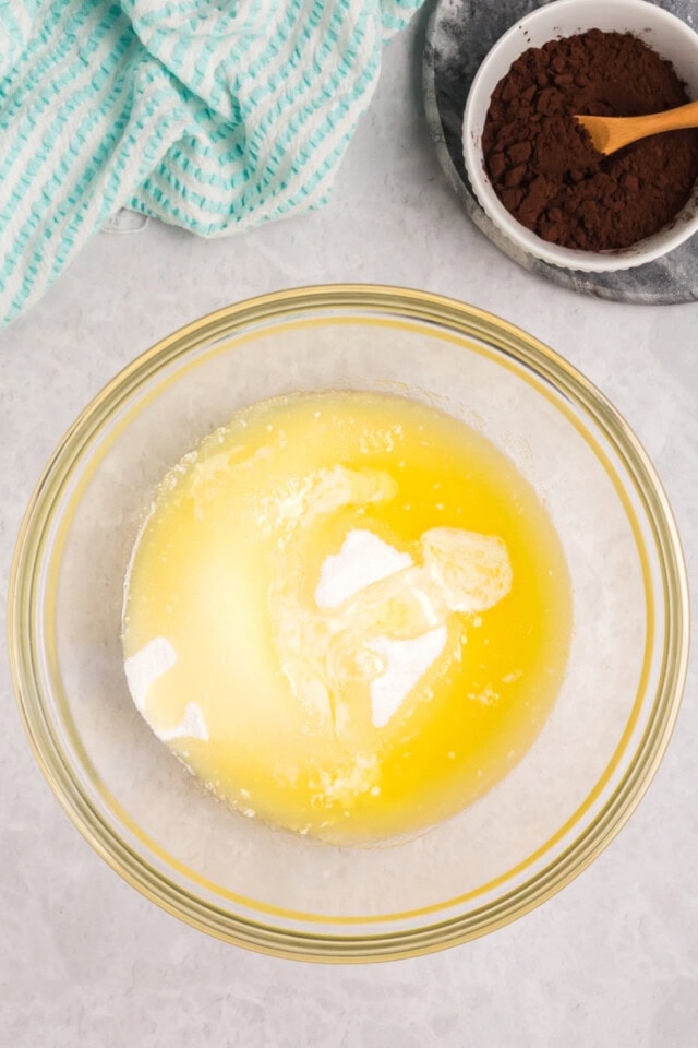 overhead view of melted butter and sugar in a mixing bowl