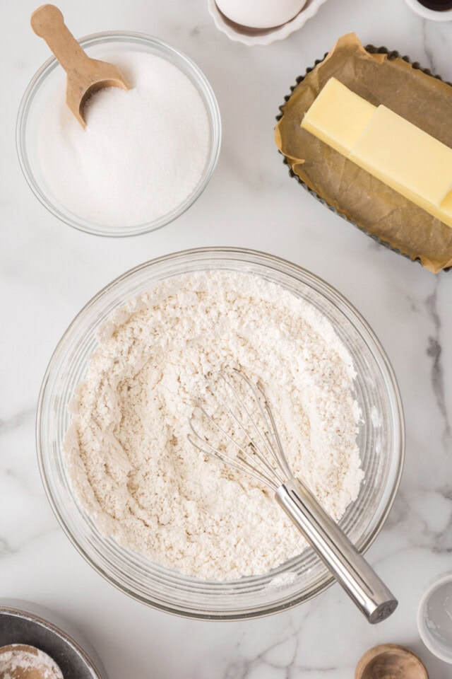overhead view of flour, baking powder, and salt combined in a mixing bowl