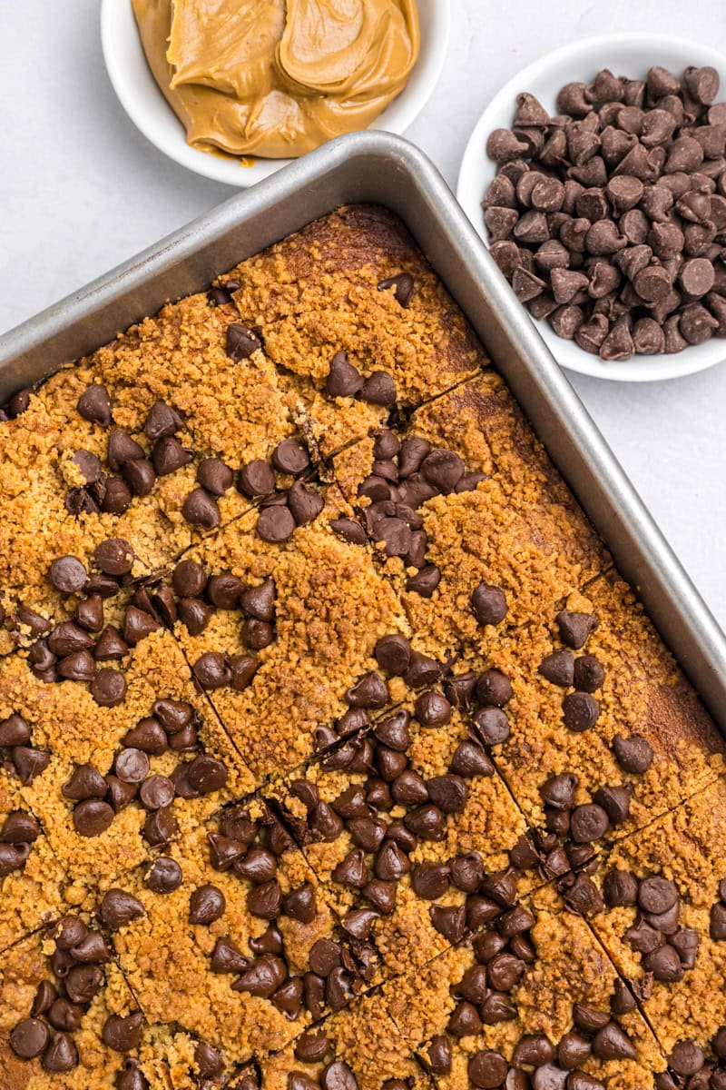 close up overhead view of freshly baked peanut butter chocolate chip cake in a 9x13 pan