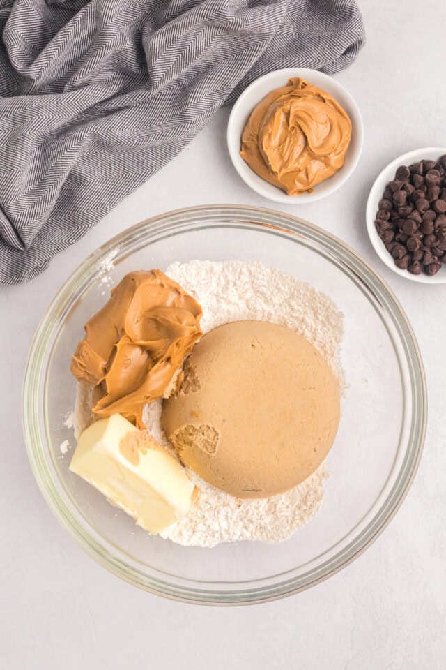 overhead view of flour, brown sugar, peanut butter, and butter in a mixing bowl