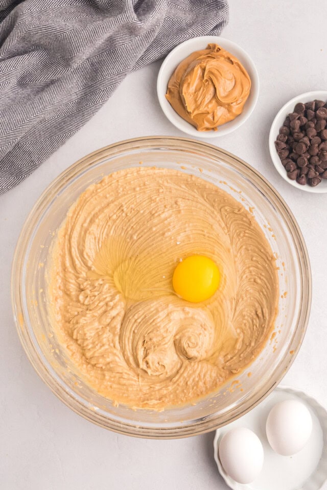 overhead view of egg added to peanut butter snack cake batter