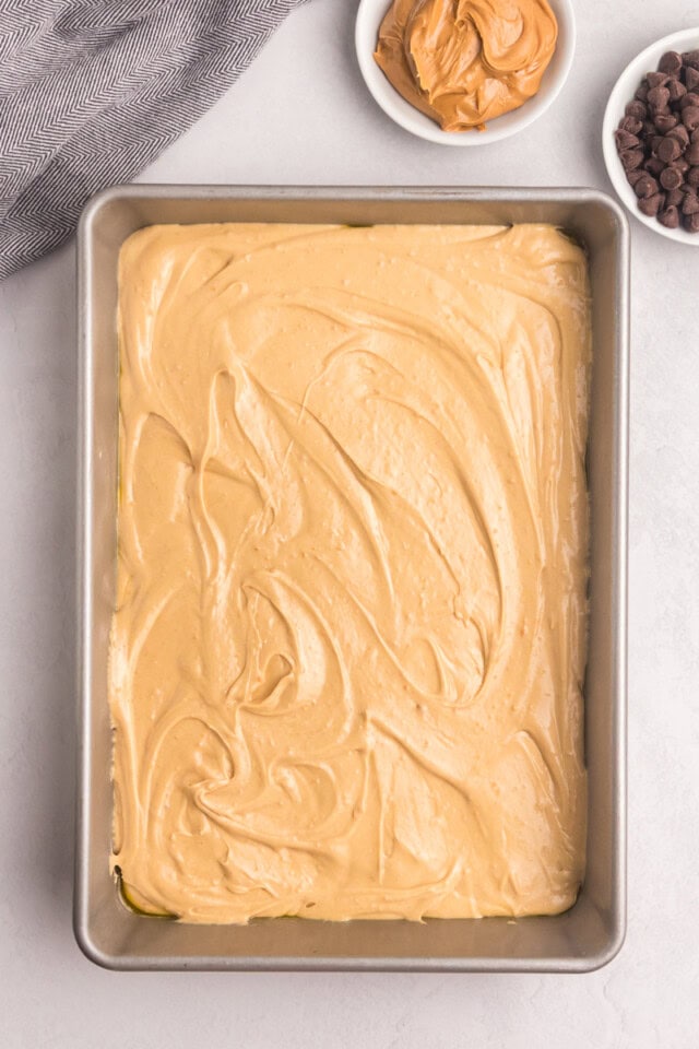 overhead view of peanut butter snack cake batter spread in a 9x13 baking pan
