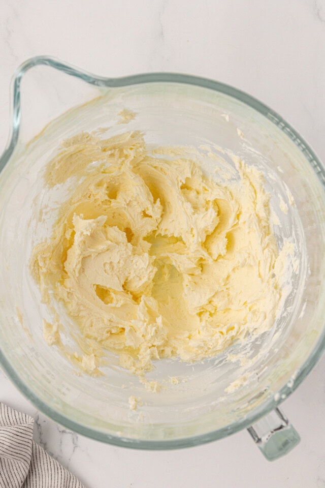 overhead view of beaten cream cheese and butter in a mixing bowl