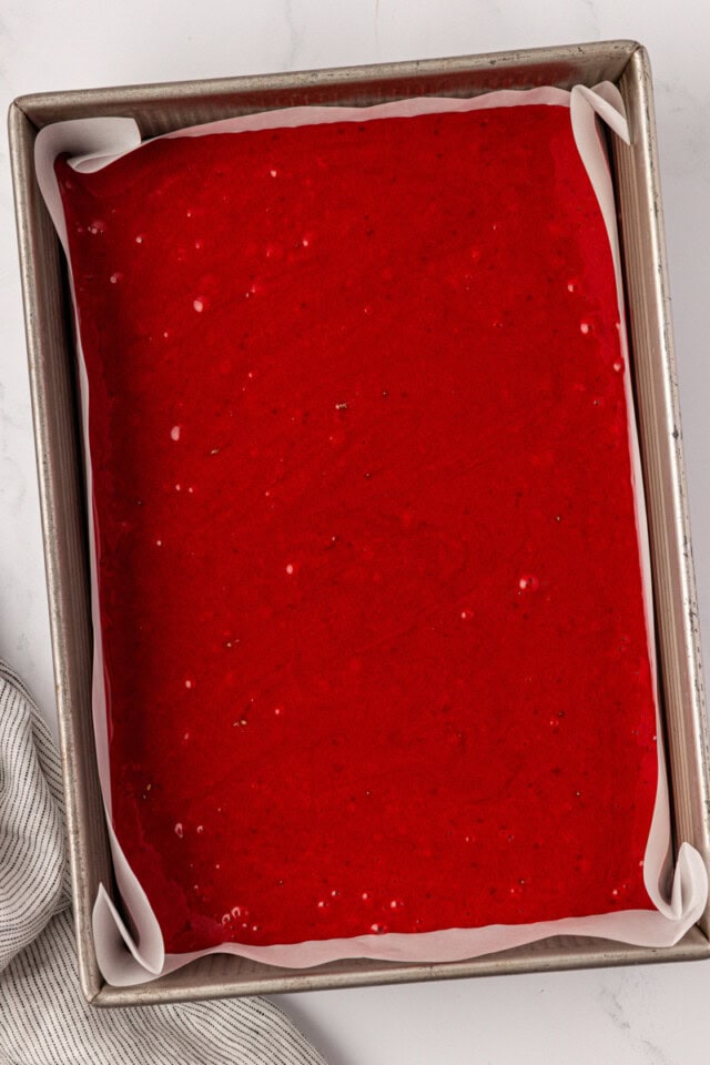 overhead view of red velvet sheet cake in a 9x13 pan ready to go into the oven