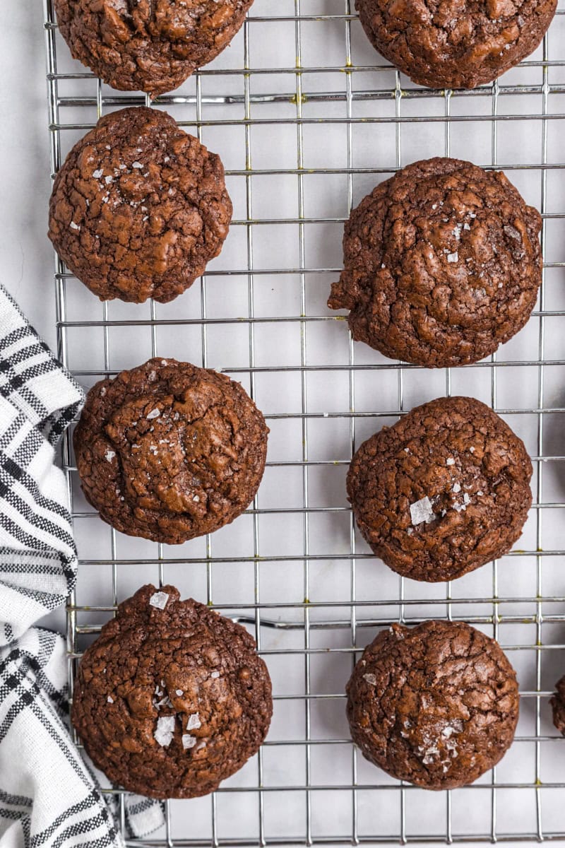 overhead view of salted chocolate truffle cookies cooling on a wire rack
