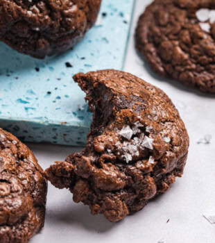 a partial salted chocolate truffle cookie topped with flaky salt