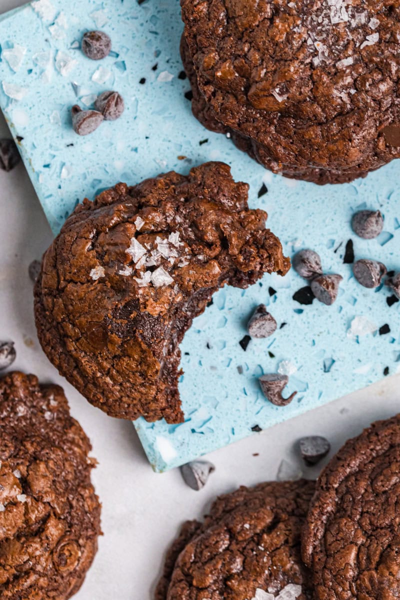overhead view of a salted chocolate truffle cookie with a bite missing