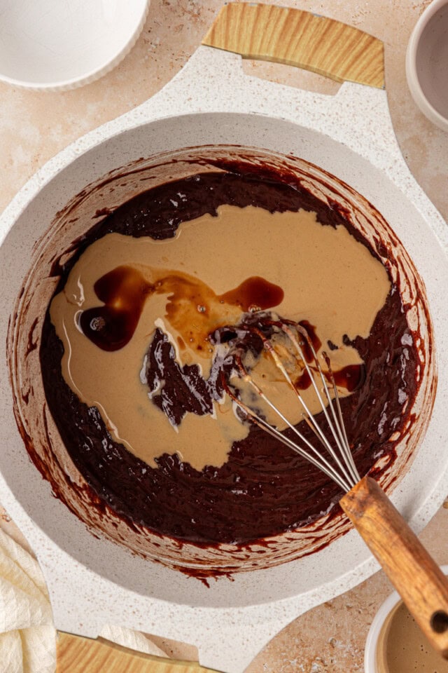 overhead view of tahini and vanilla added to chocolate mixture for tahini brownies