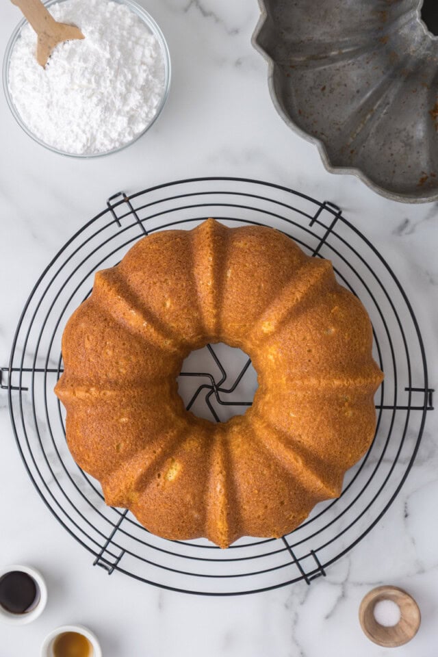 overhead view of freshly baked vanilla Bundt cake cooling on a wire rack