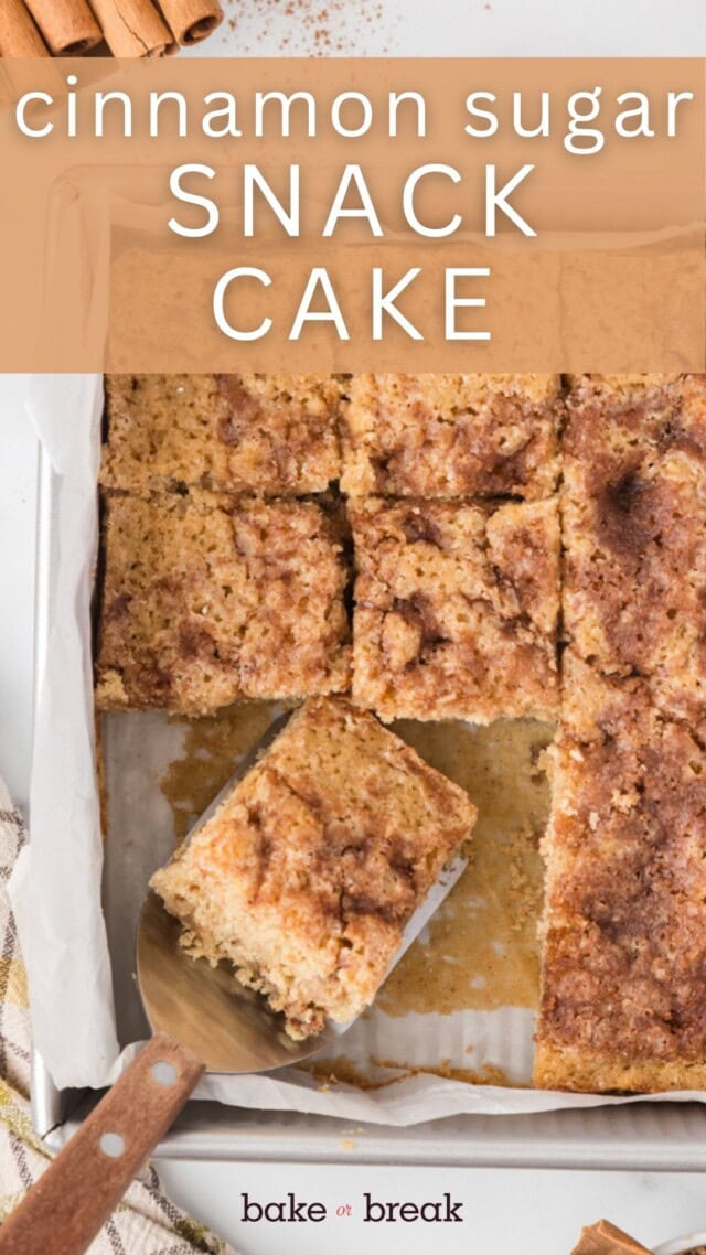 overhead view of slices of cinnamon sugar snack cake in a parchment-lined baking pan; text overlay "cinnamon sugar snack cake bake or break"