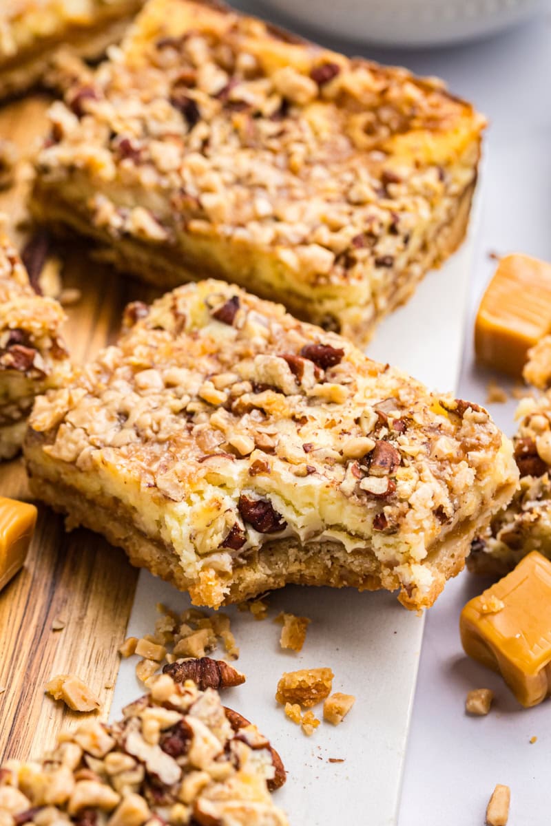close-up of a caramel cheesecake bar showing gooey caramel layer