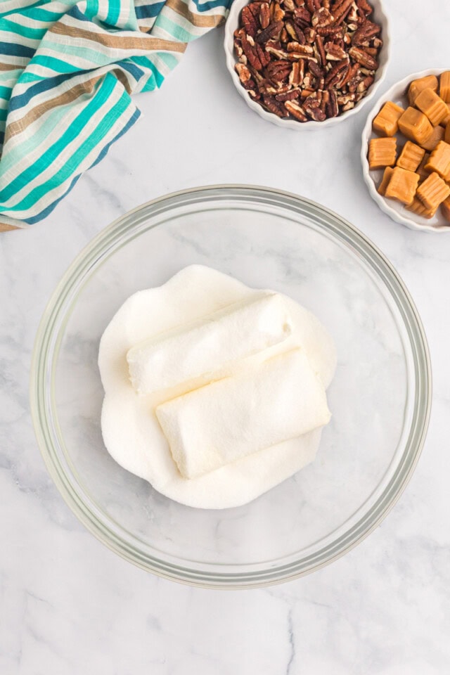 overhead view of cream cheese and sugar in a mixing bowl