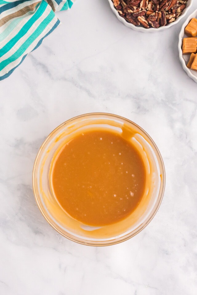 overhead view of melted caramels in a small glass bowl