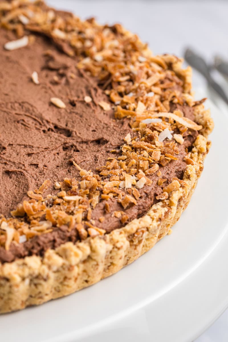 close up view of chocolate mousse pie topped with toasted coconut