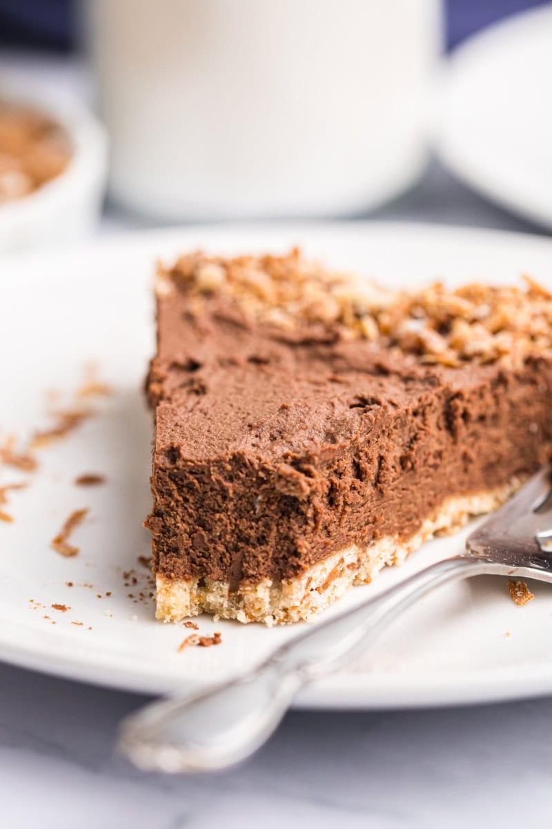 close up of a slice of chocolate mousse pie with a bite missing