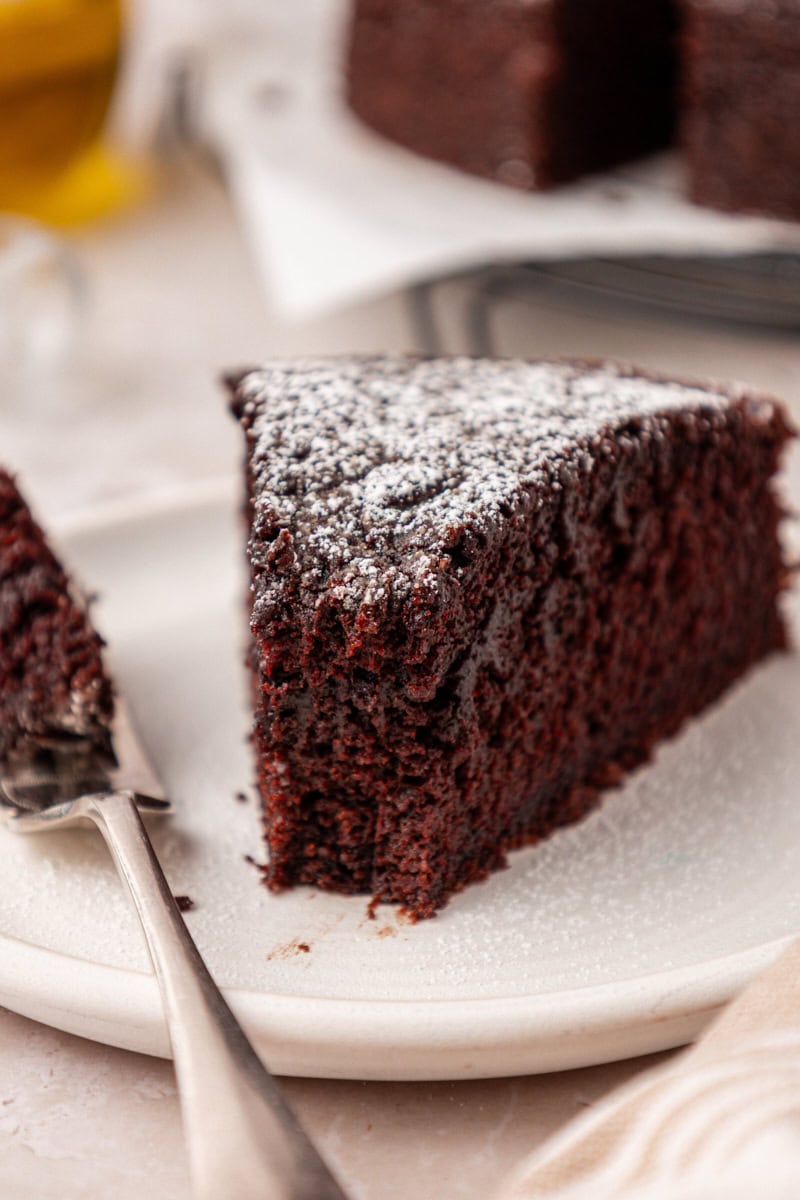 a slice of chocolate olive oil cake with a bite on a fork