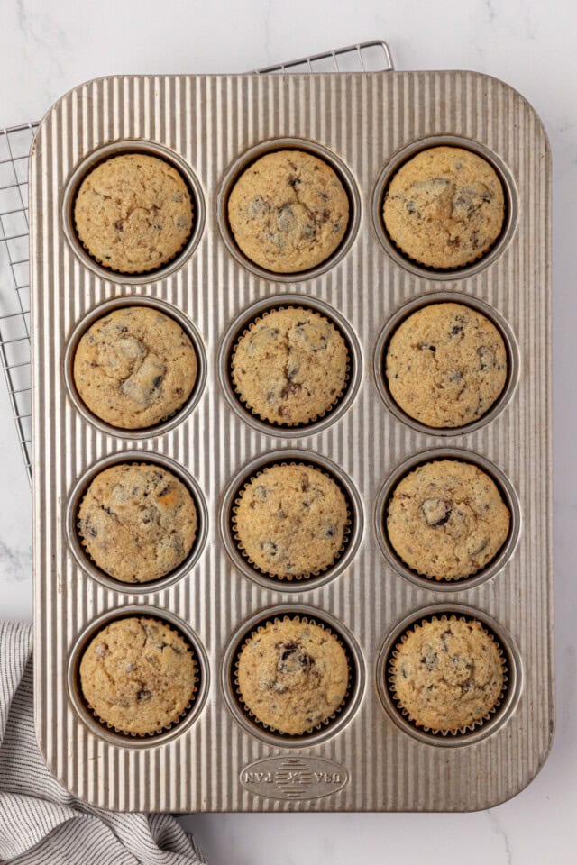 overhead view of freshly baked cookies and cream cupcakes in a muffin pan